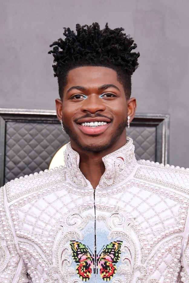 Lil Nas X poses on the Grammys red carpet in 2022