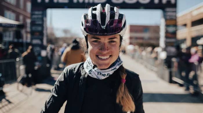 A smiling woman wearing a helmet