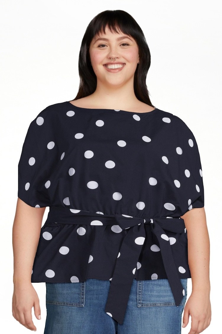 A model with the top in white polka dot on