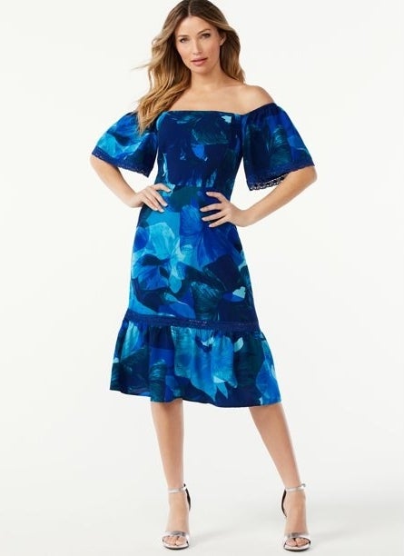 The dress in imperial blue pomona petals on a model