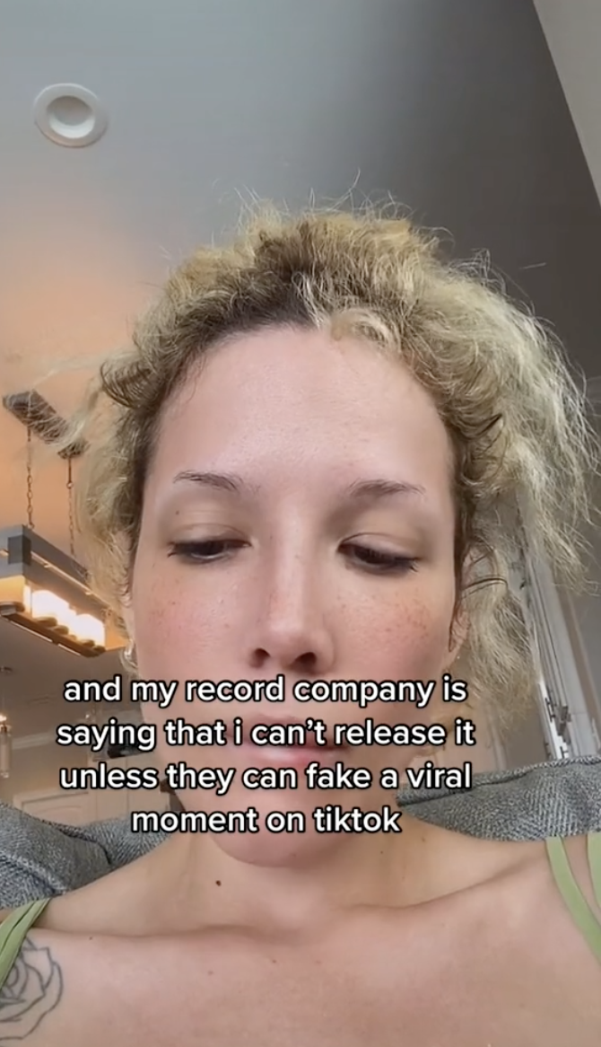 Closeup of Halsey on TikTok with text that reads, &quot;and my record company is saying that i can&#x27;t release it unless they can fake a viral moment on tiktok&quot;