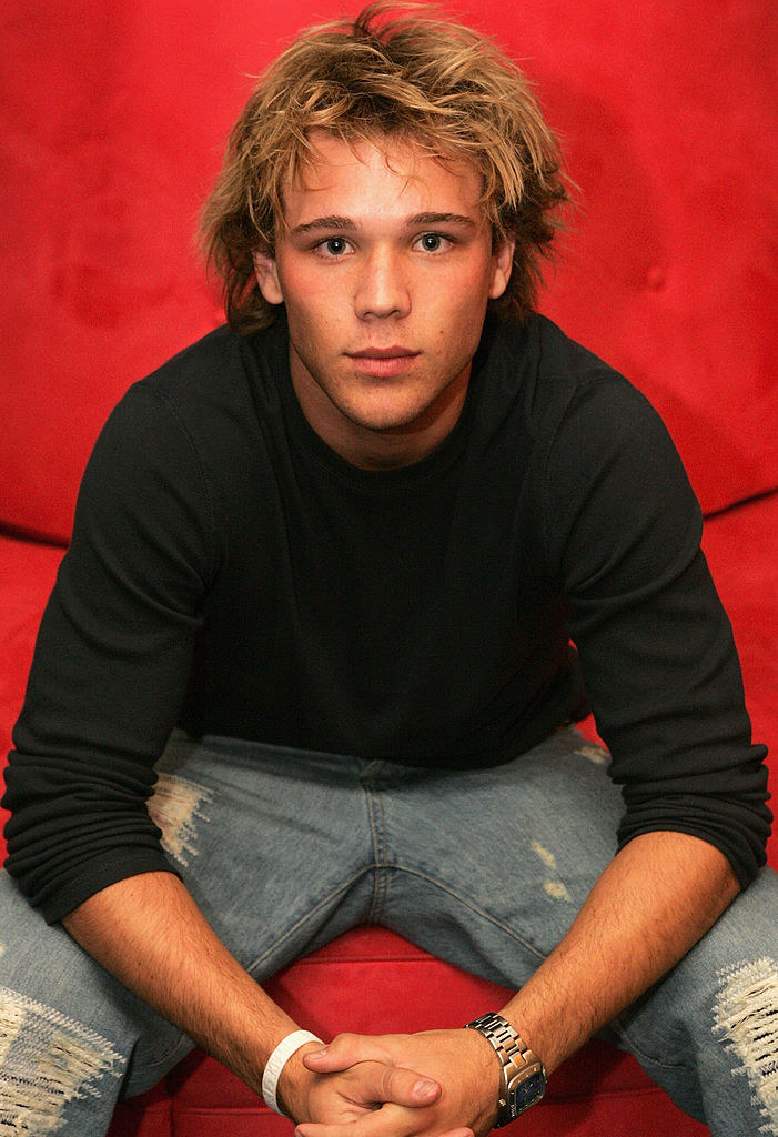 Lincoln Lewis sits on a chair