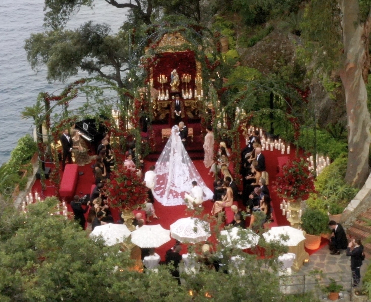 An aerial shot of the ceremony, which is a heavily wooded area overlooking the water