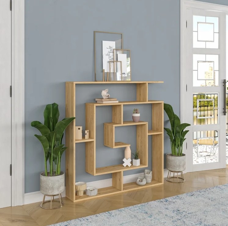 An image of a oak geometric bookcase with six tiers of different heights and widths