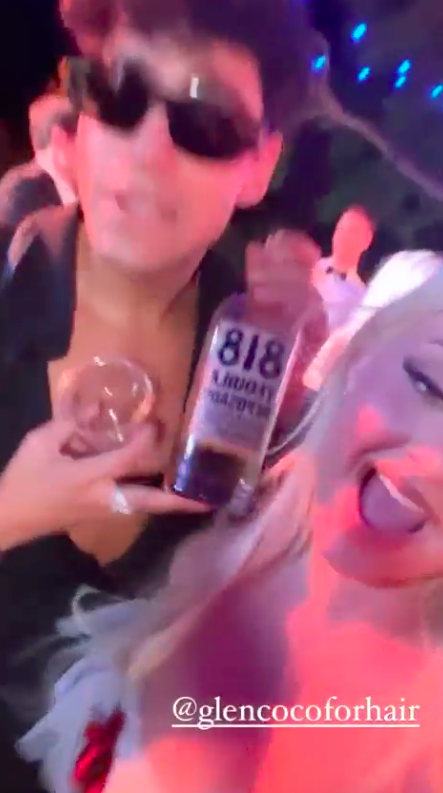 A guest holding up a bottle of tequila