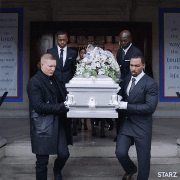 Men carrying a casket out of a funeral home