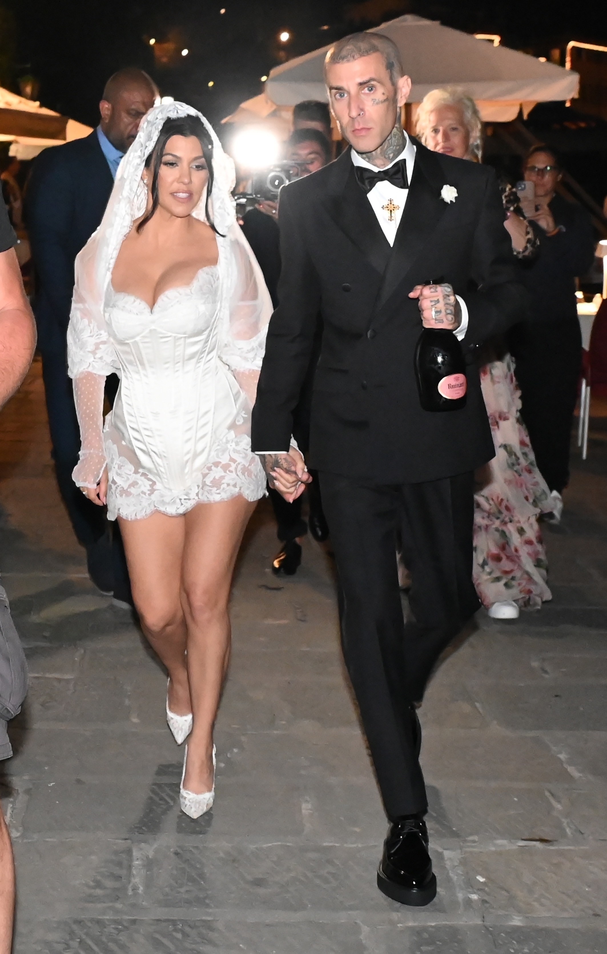Kourtney is now wearing a much smaller veil that falls across her shoulders