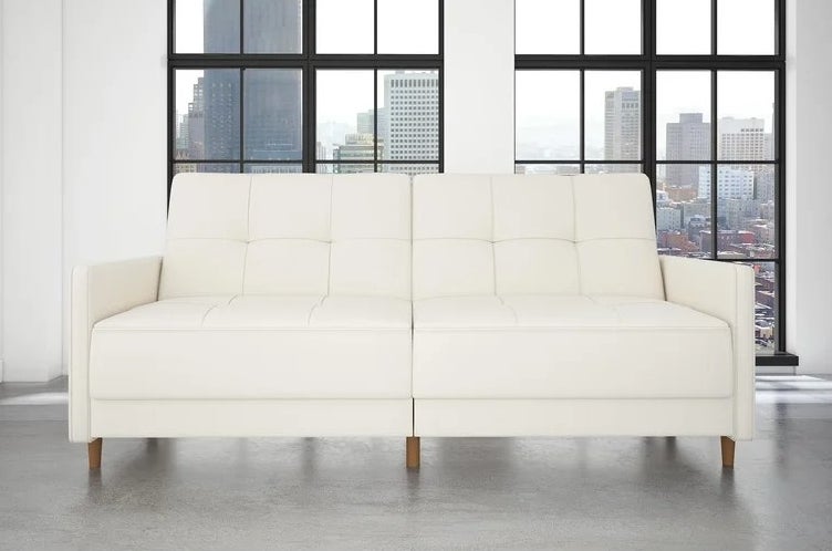 An image of a white convertible sofa with faux leather upholstery
