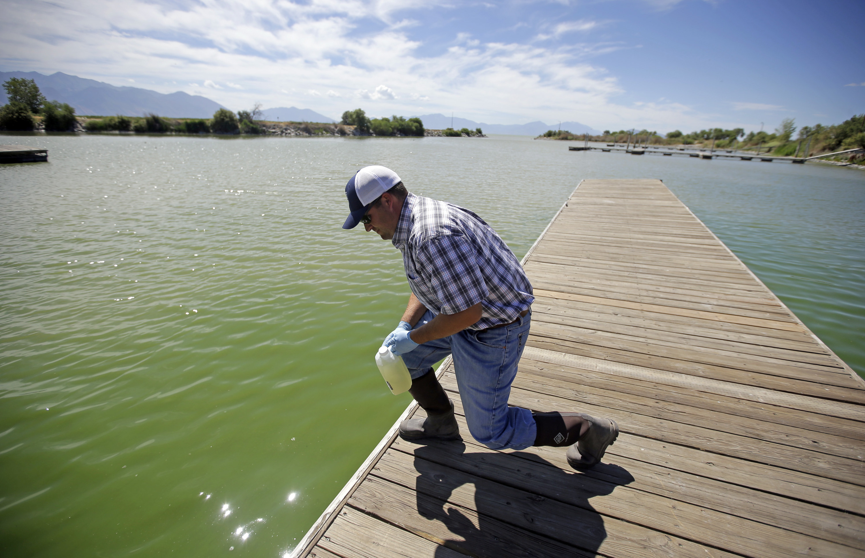Jason Garrett, water quality bureau director at the Utah County Health Department, looks at the water in Utah Lake