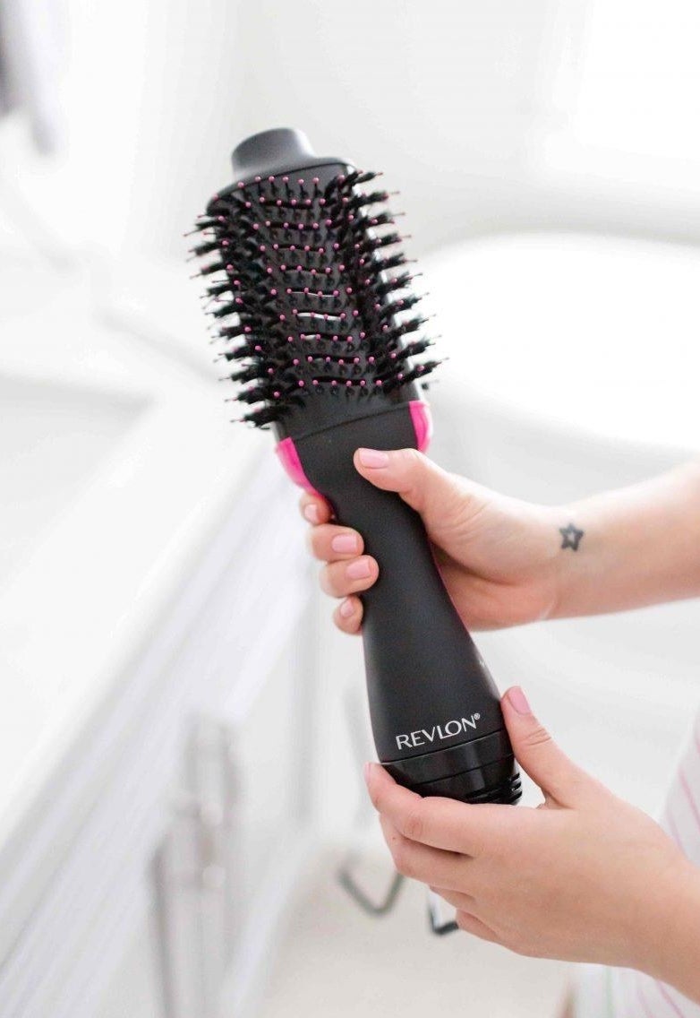 a reviewer holds the hairdryer
