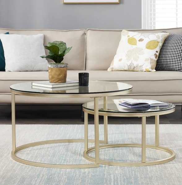 An image of two gold nesting tables