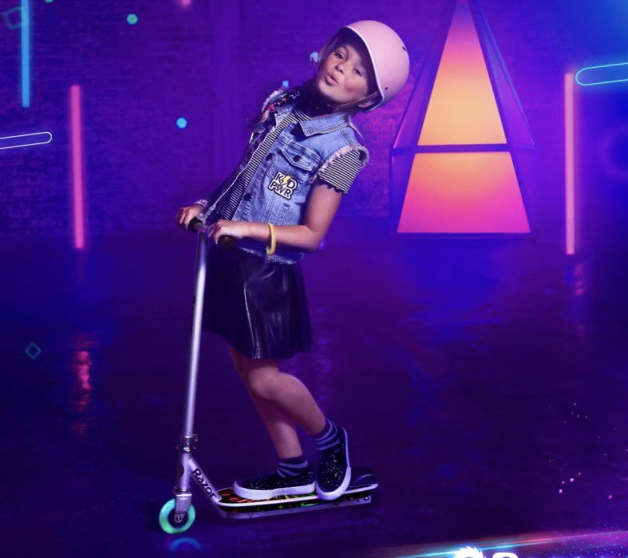 A kid model on the light-up scooter with helmet