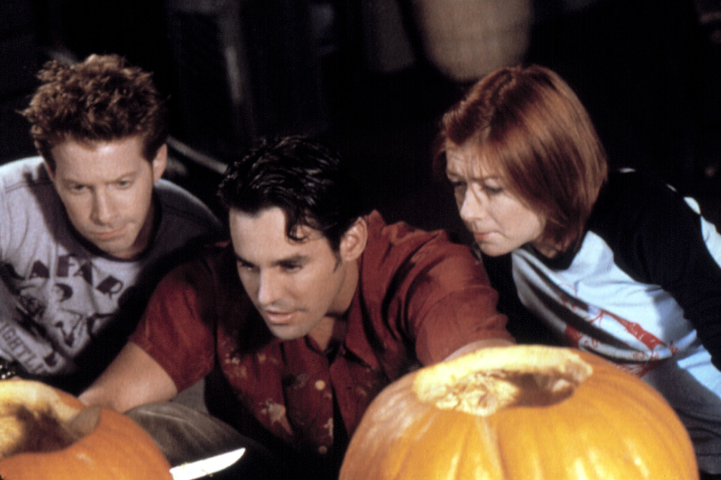 Oz, Xander, and Willow carve pumpkins