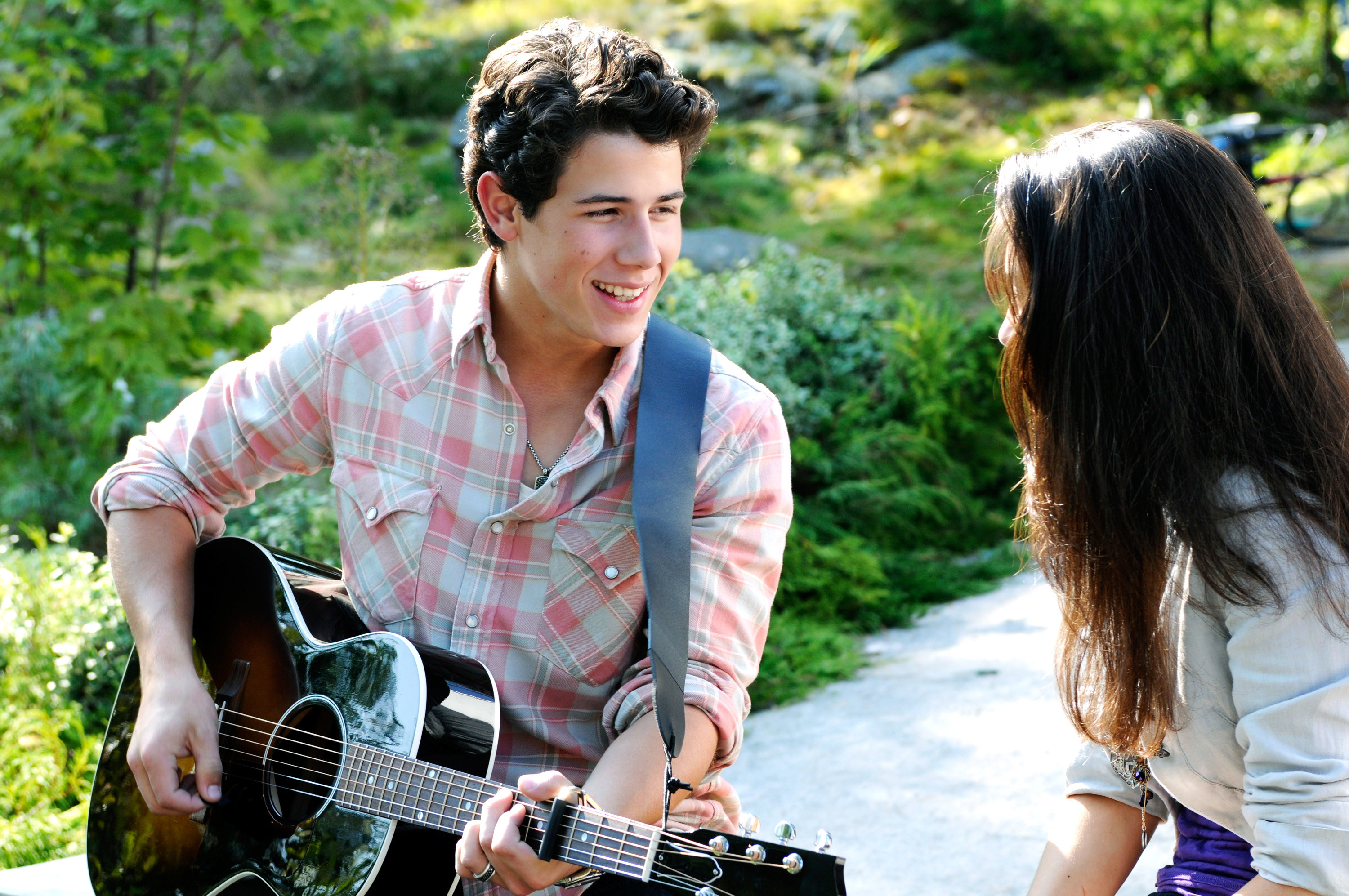 Nat playing guitar and singing in Camp Rock