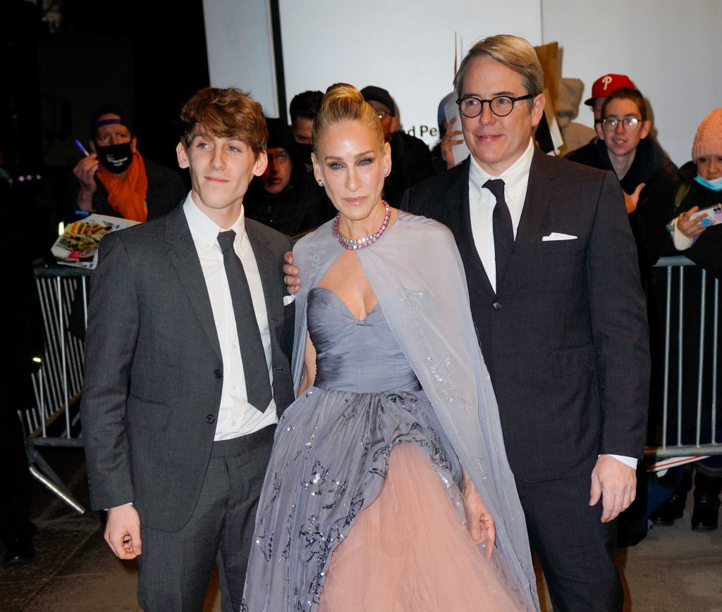 Sarah Jessica Parker wears a strapless gown with a shawl while James Wilkie Broderick and Matthew Broderick wear dark suits