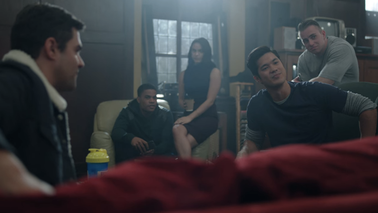 Reggie makes fun of Jughead while other students look on