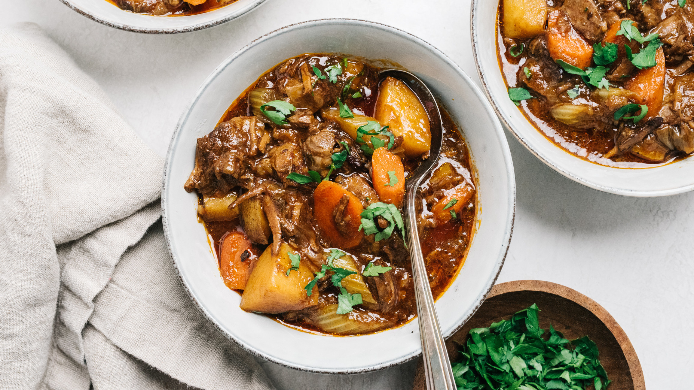 Bowls of beef stew with potatoes.