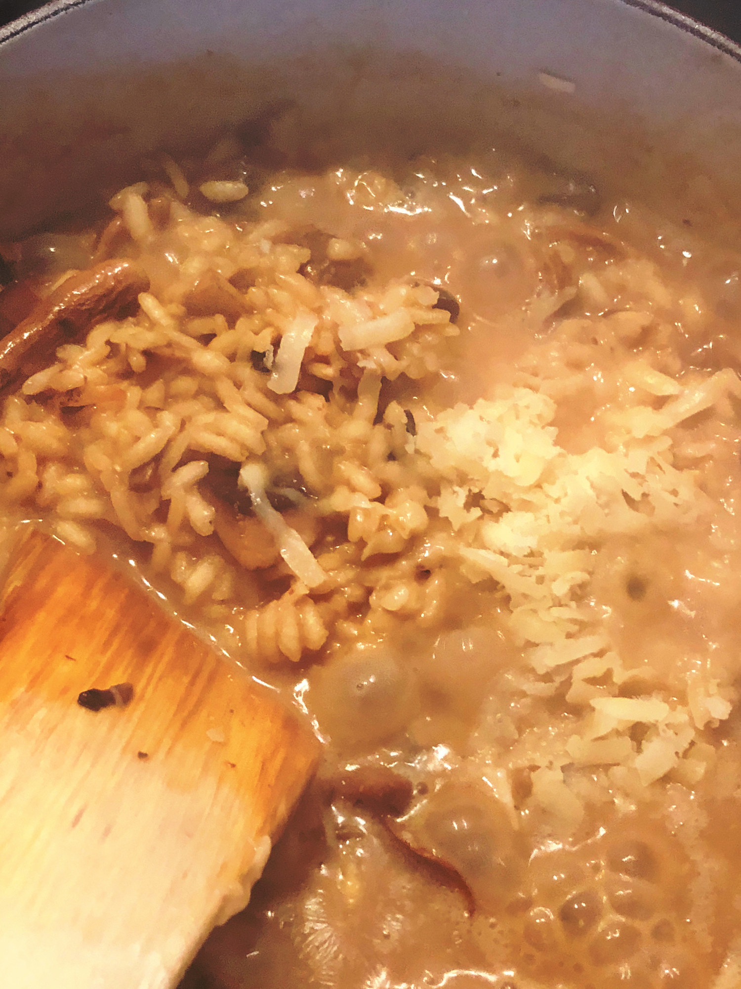 Mushroom risotto cooking in a pan.