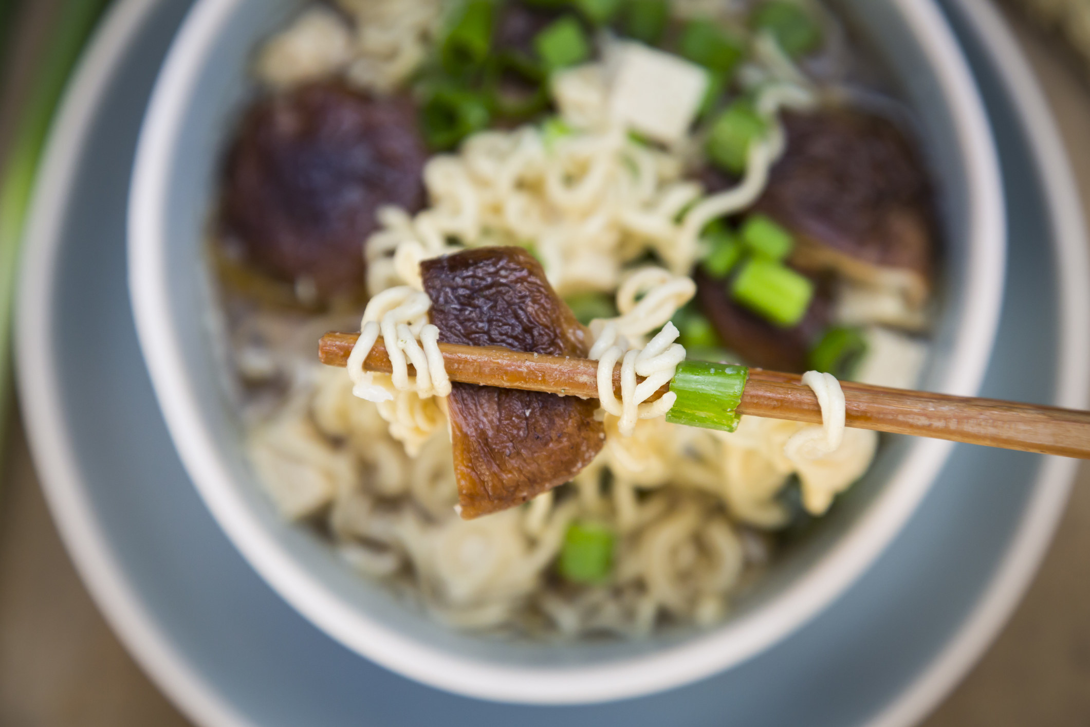 Ramen soup with mushrooms and scallions.