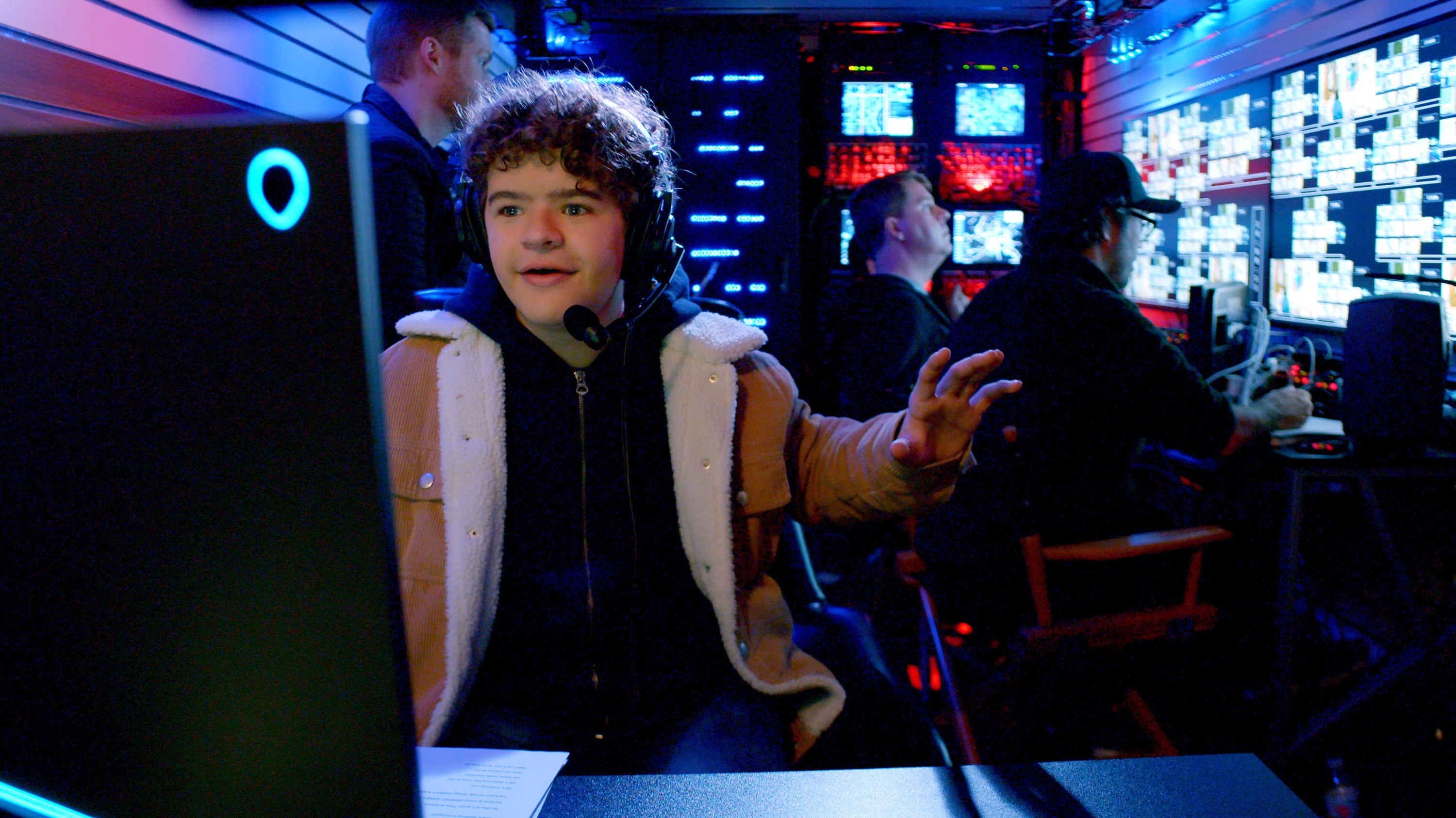 Gaten at a computer in a scene from Prank Encounters