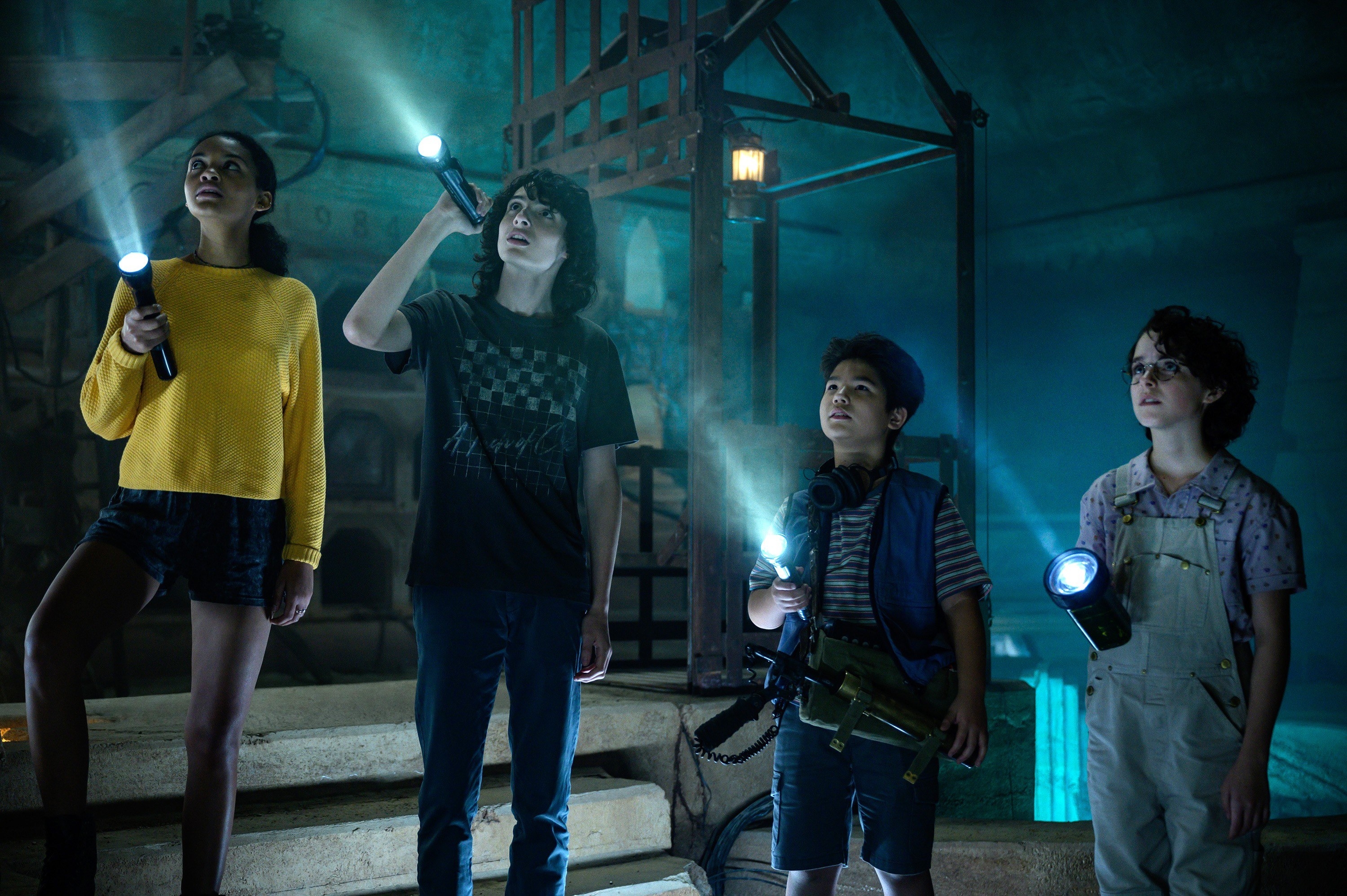 Four young people holding flashlights