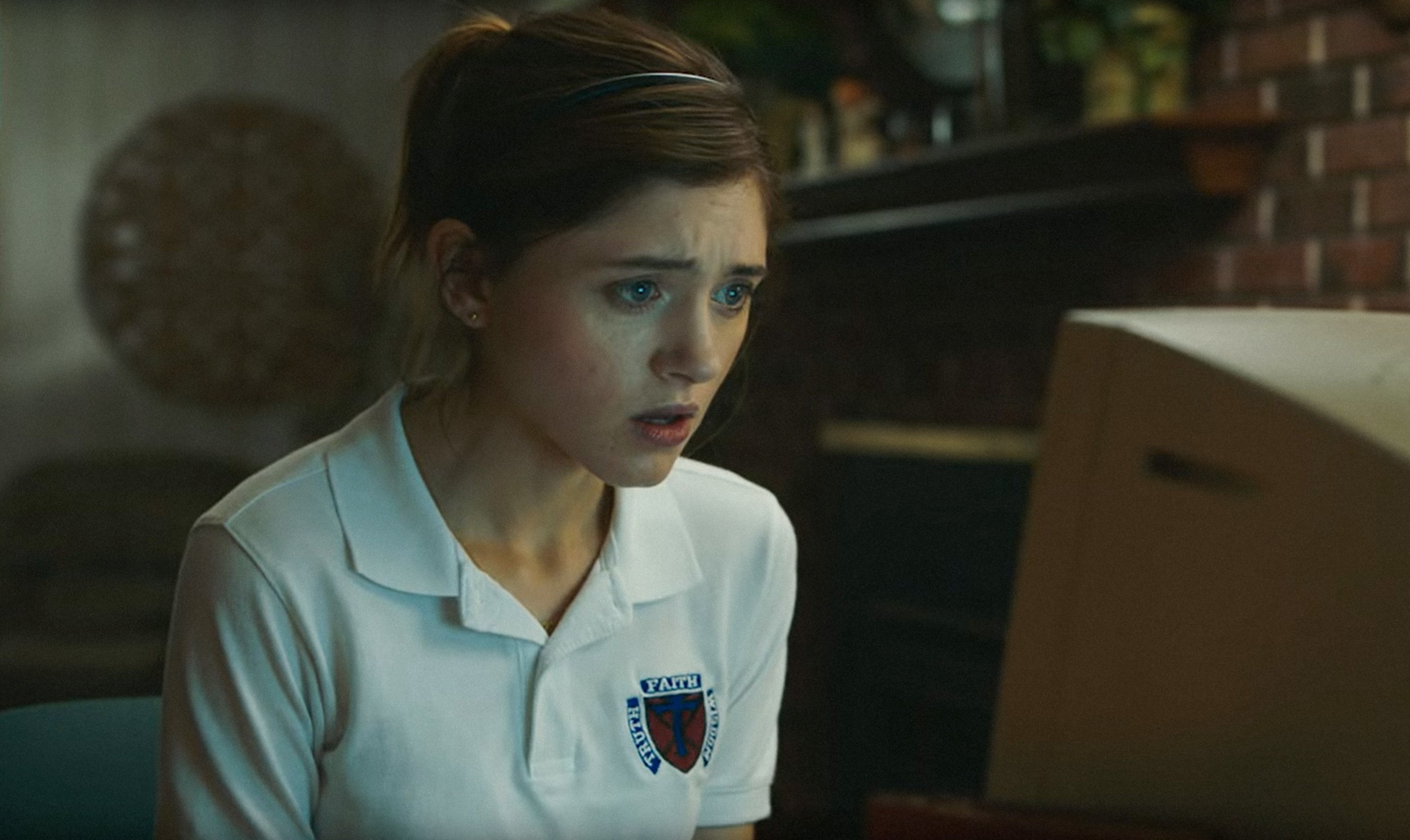 Natalia staring intensely at a computer screen in a scene from Yes, God, Yes