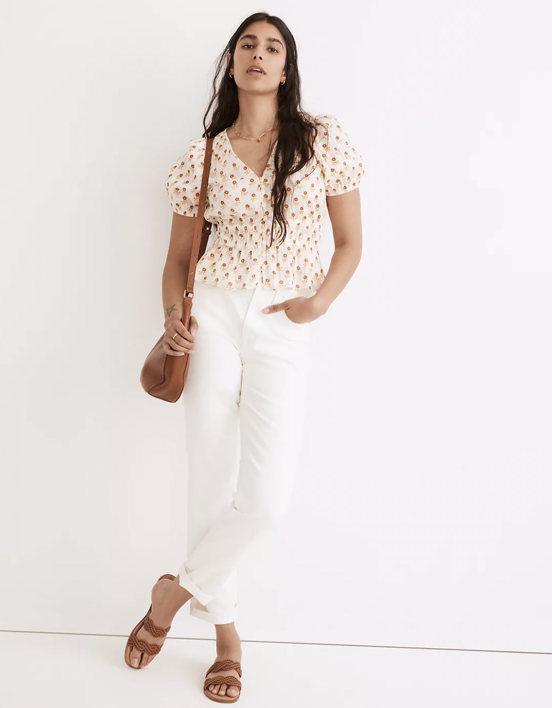 model wearing the v-neck short sleeve blouse with white jeans
