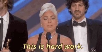 Lady Gaga at a microphone and saying &quot;This is hard work&quot;