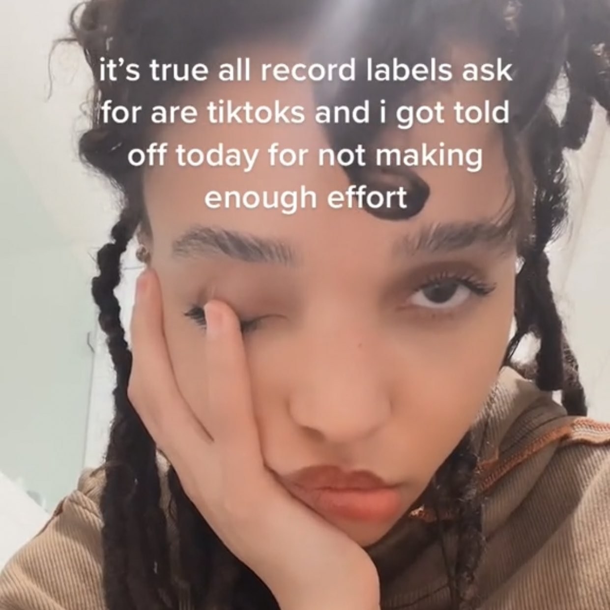 A screenshot from a video that says &quot;It&#x27;s true, all record labels ask for are TikToks and I got told off for not making enough effort&quot;