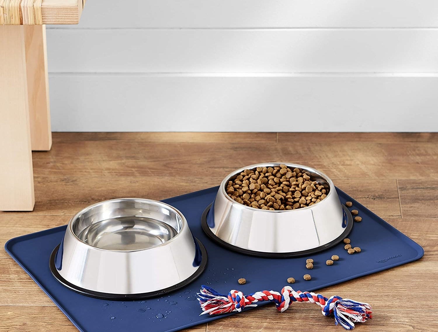 a silicone food mat under two dog bowls filled with kibble and water