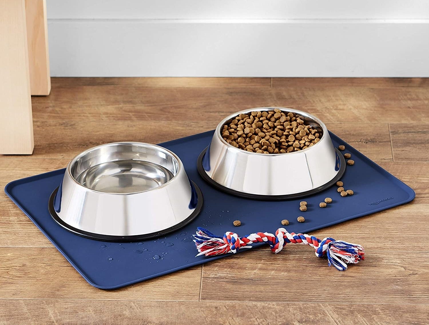a silicone food mat under two dog bowls filled with kibble and water