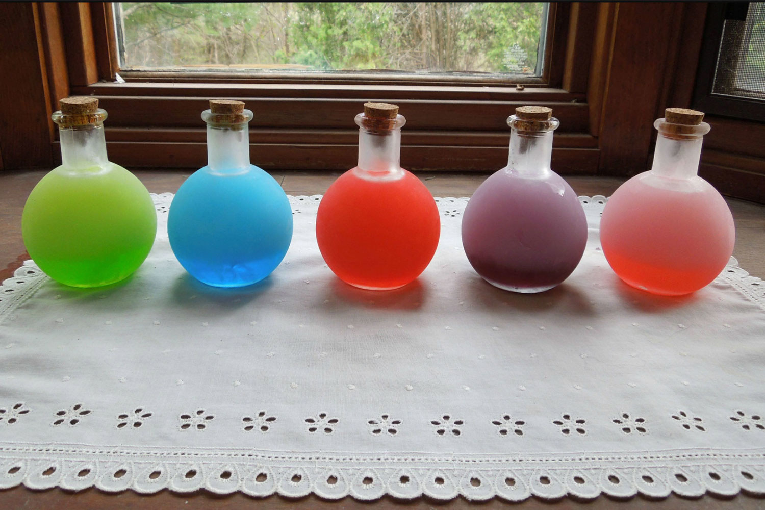 Different pitchers of colored vodka