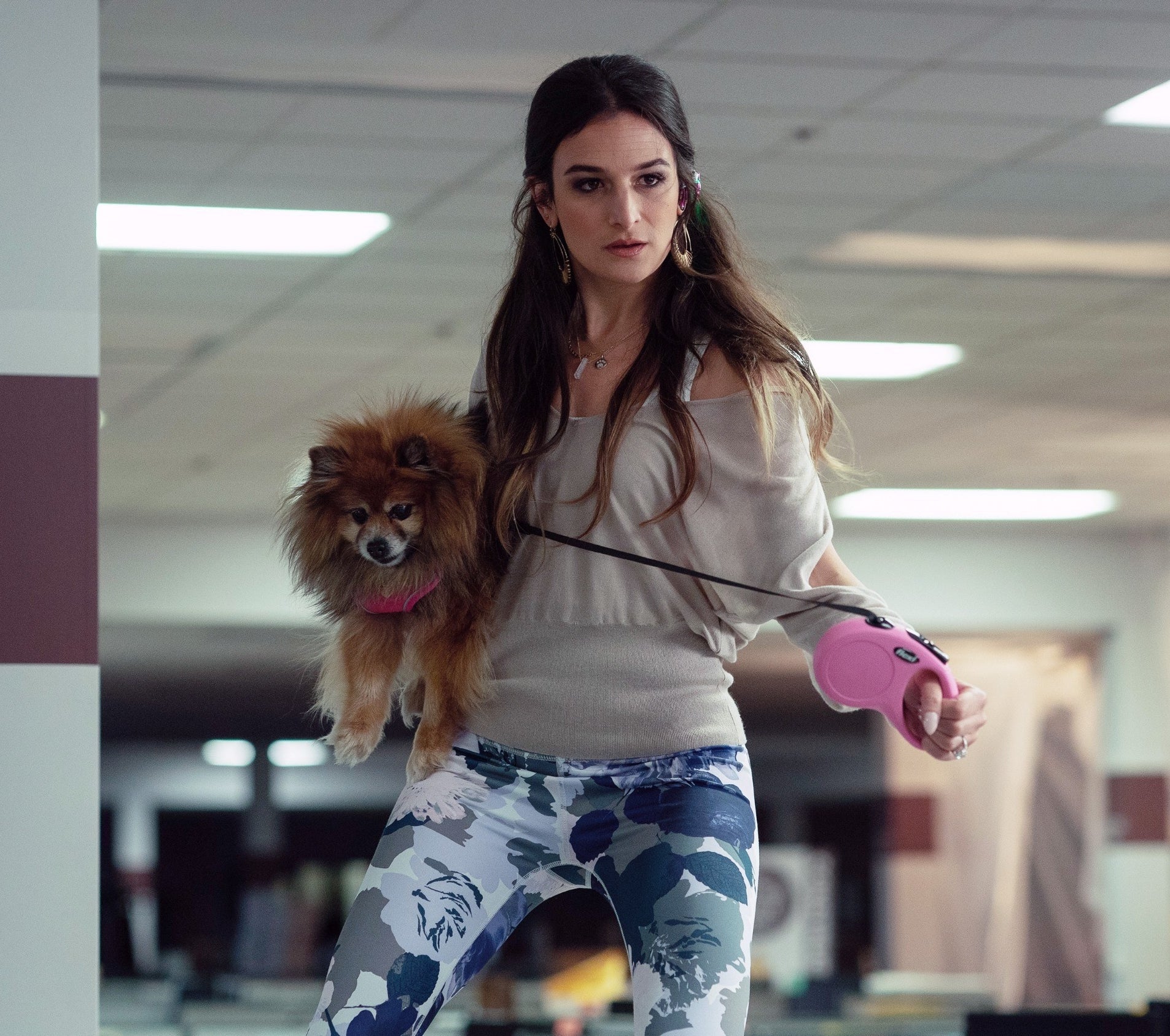 Jenny with long hair holding her small dog in her arms