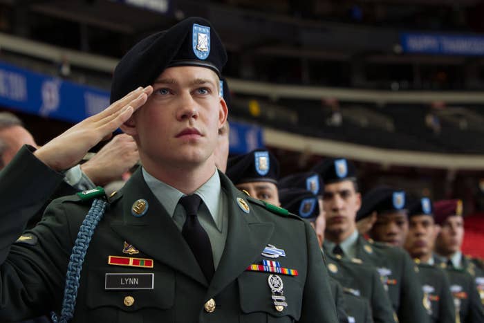 Joe Alwyn, dressed as a soldier, salutes