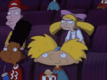 Hey Arnold gif of Arnold eating popcorn in a theater