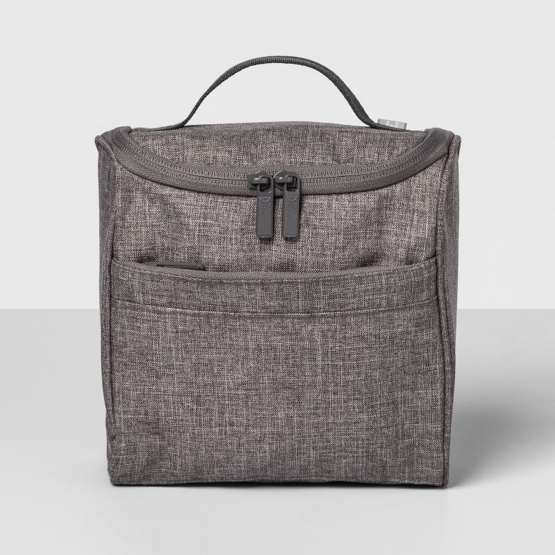 An image of a grey hanging toiletry bag that can be tucked inside a suitcase