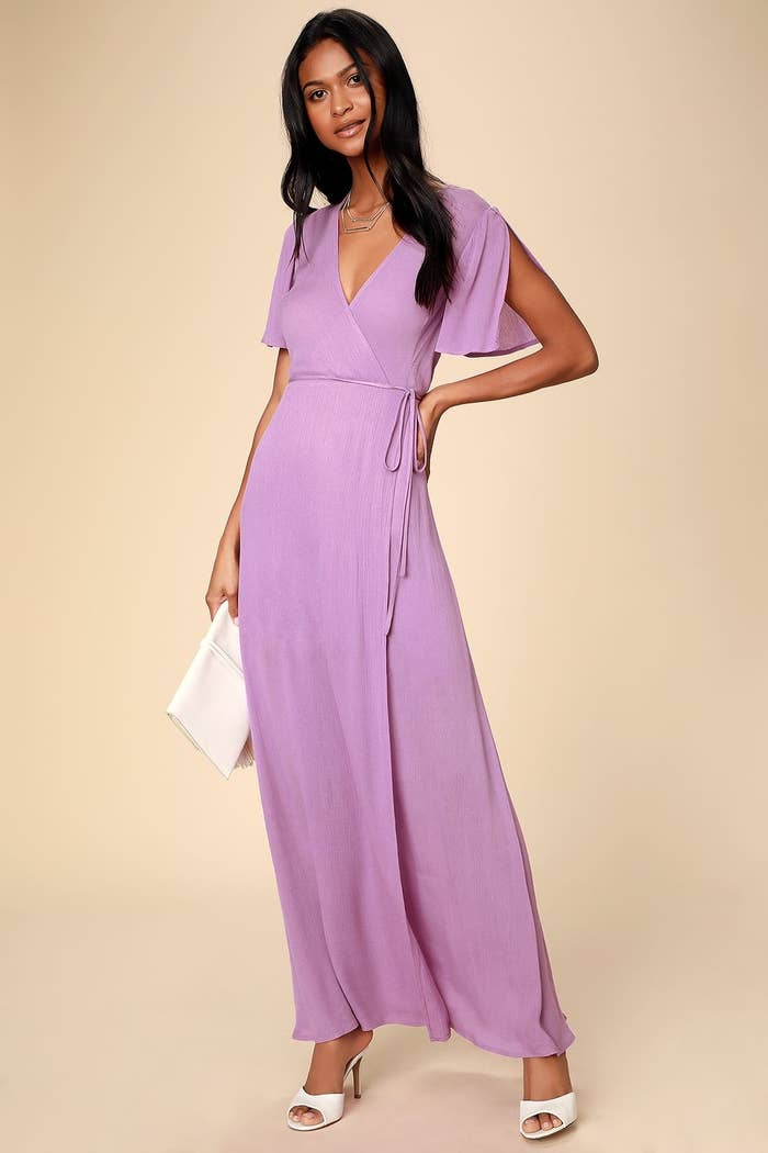 model in orchid colored maxi wrap dress with fluttery sleeves