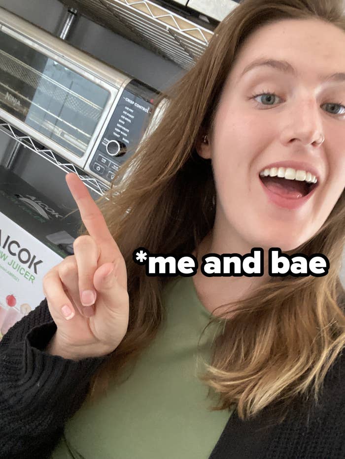 Woman pointing to an air fryer with the text &quot;me and bae&quot;