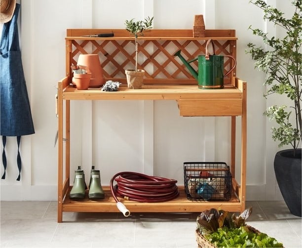 Potting bench styled with various gardening tools and accessories
