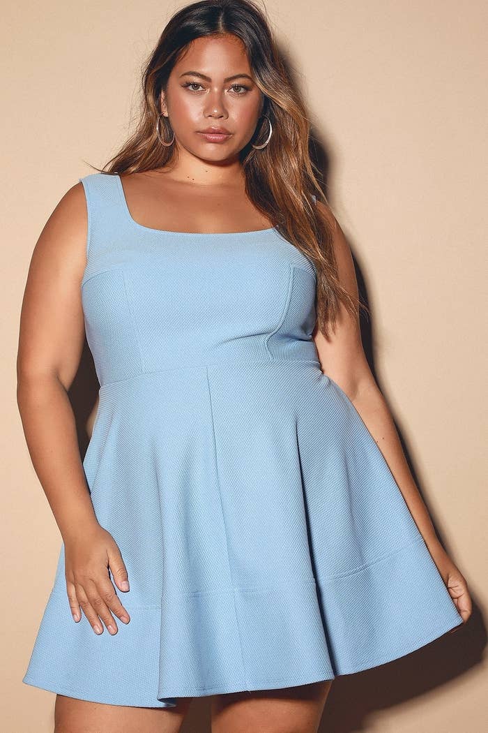 model wearing a light blue knit thigh-length tank dress with a square neckline