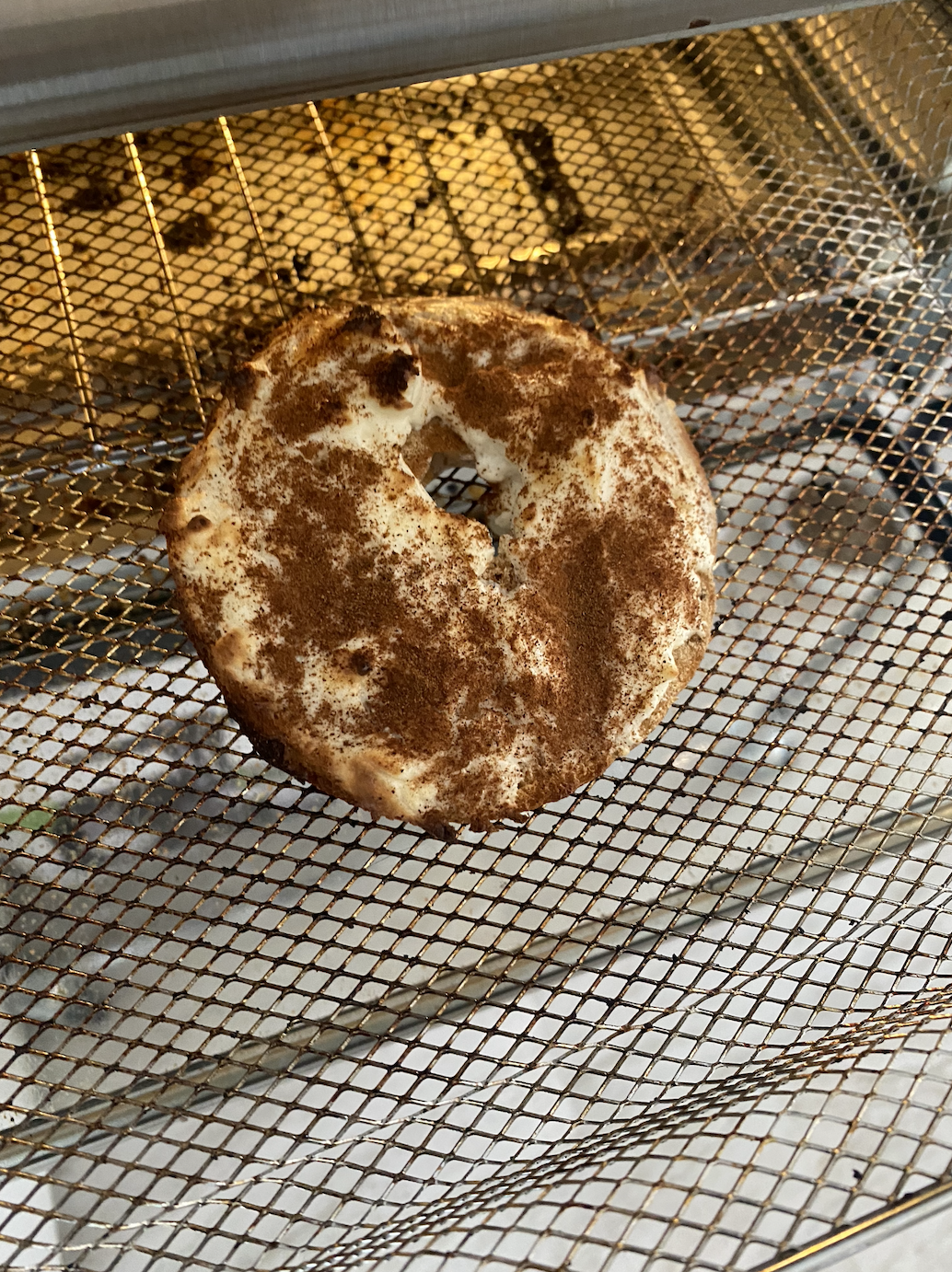 One bagel slice with cream cheese and cinnamon