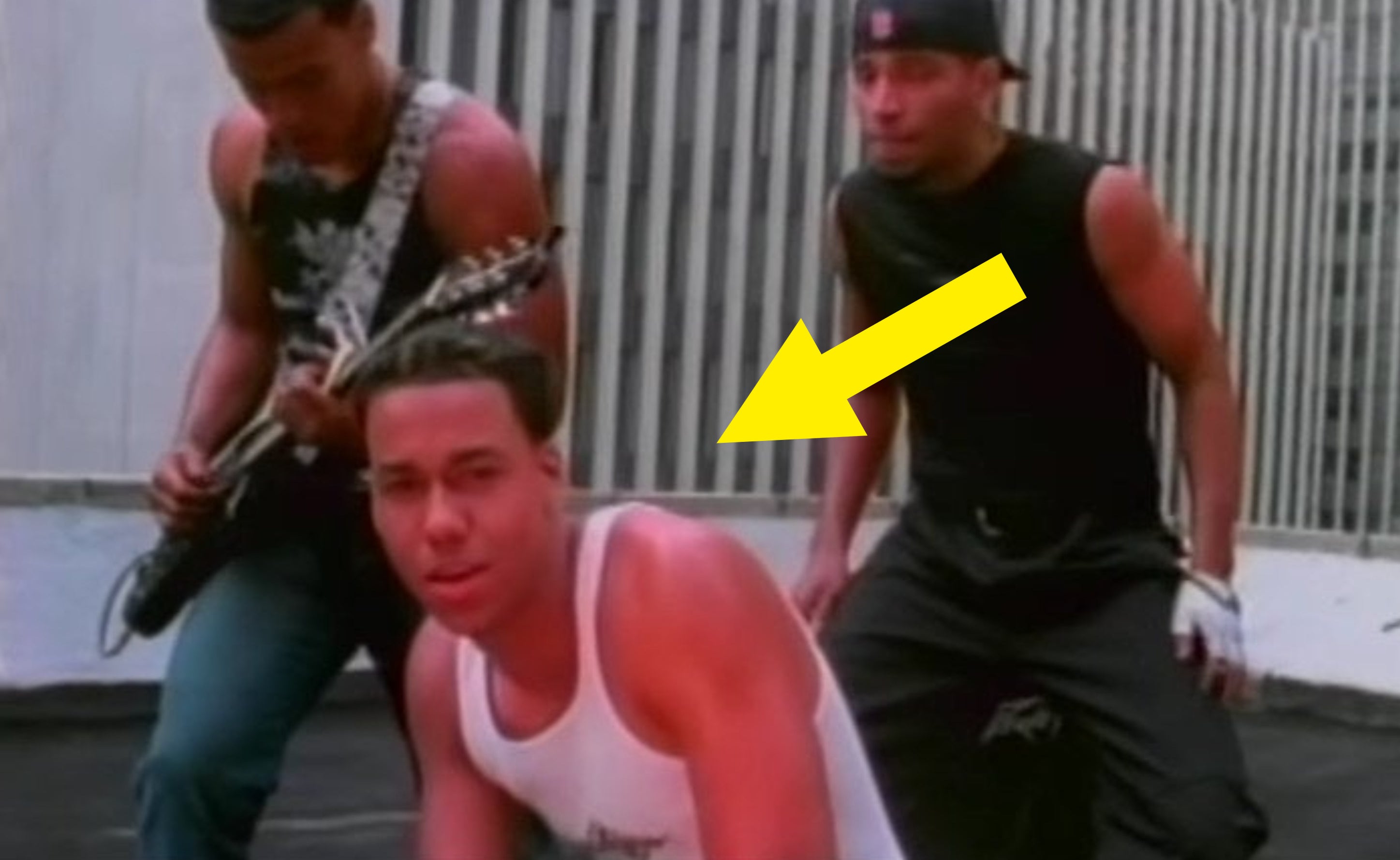 Screenshot from video with arrow pointing to Romeo in a sleeveless shirt