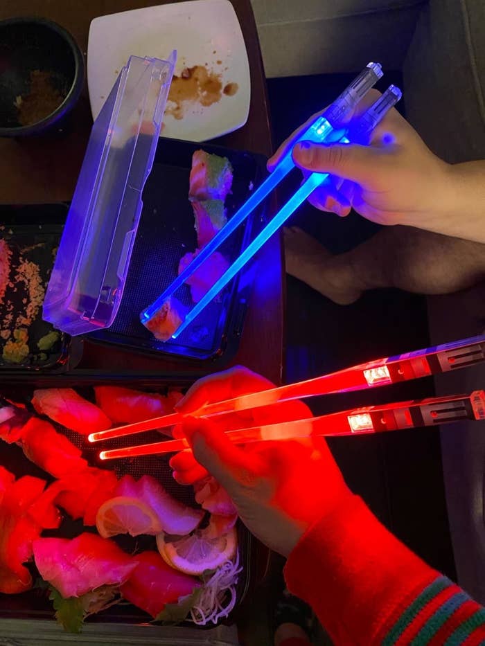 reviewer using the light up chopsticks