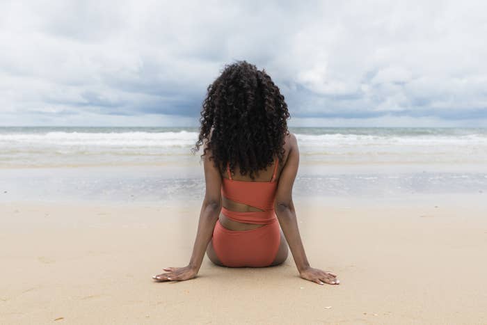 A woman sitting on a beach