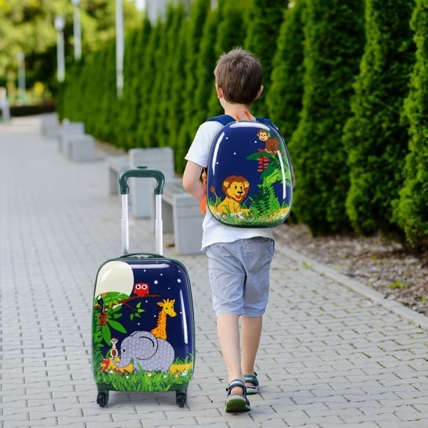 Boy walking with luggage set