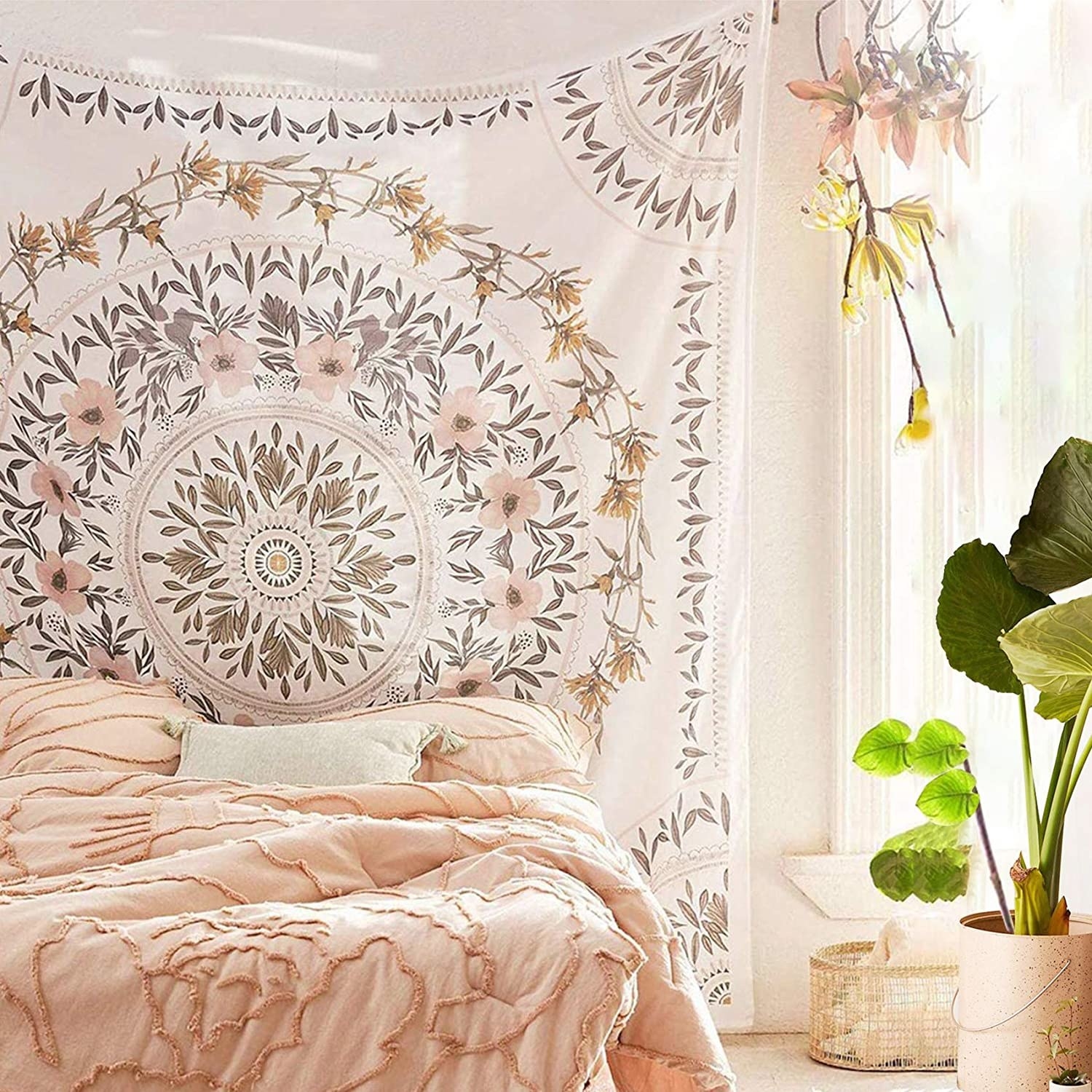 a floral wall tapestry hung on a wall behind a bed