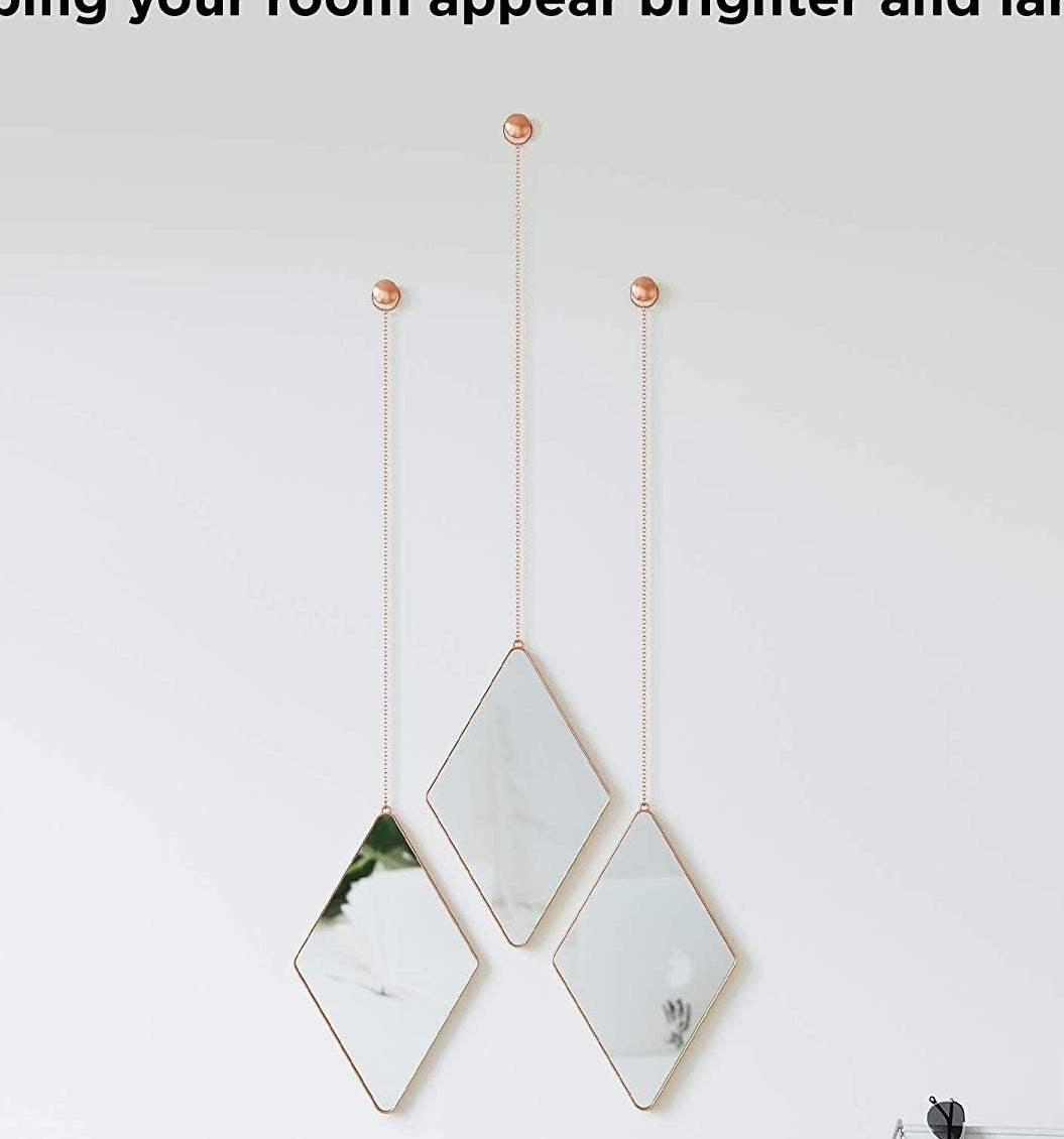 the diamond-shaped mirrors hanging on a wall