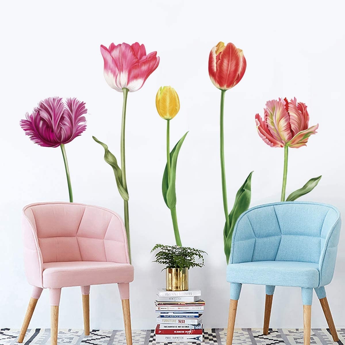 floral wall decals behind chairs and a stack of books