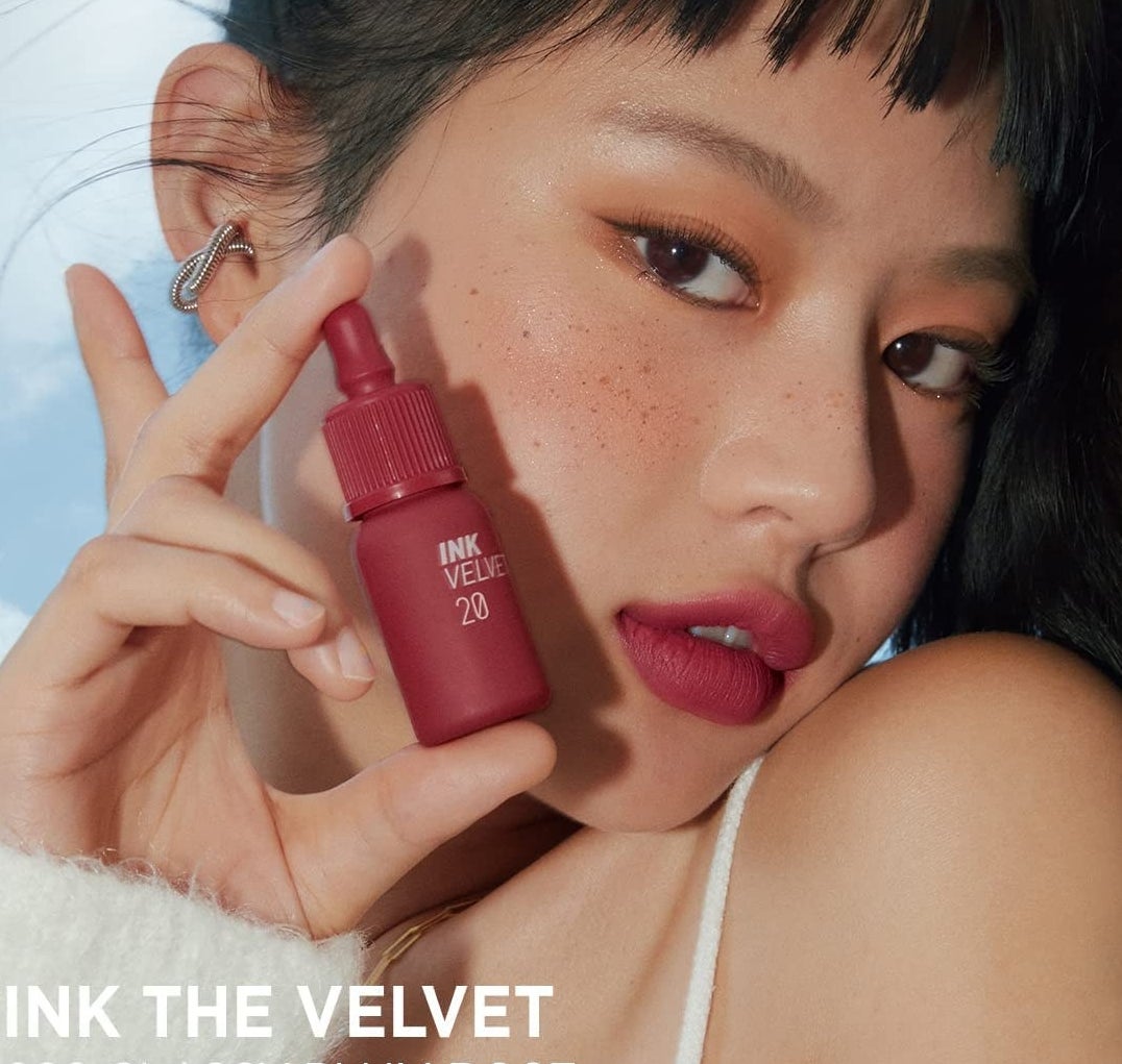 a model holding the lipstick bottle