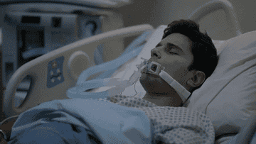 someone on the hospital bed with a tube in their mouth